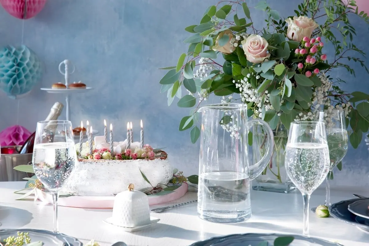 beautiful birthday dinner setting with roses and crystal glasses