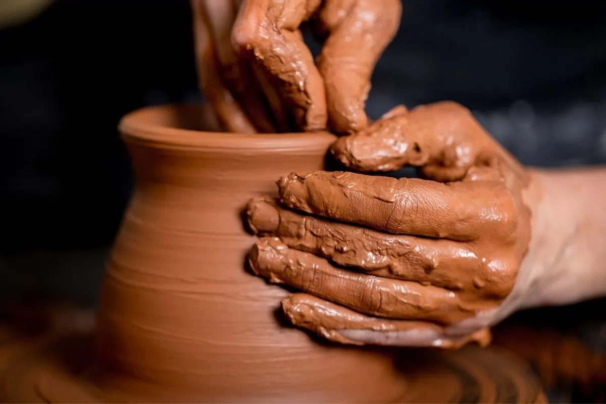 potter hands working on a clay pot