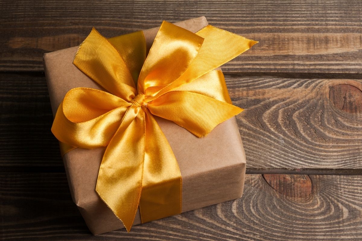 gift wrapped in brown paper with a yellow bow