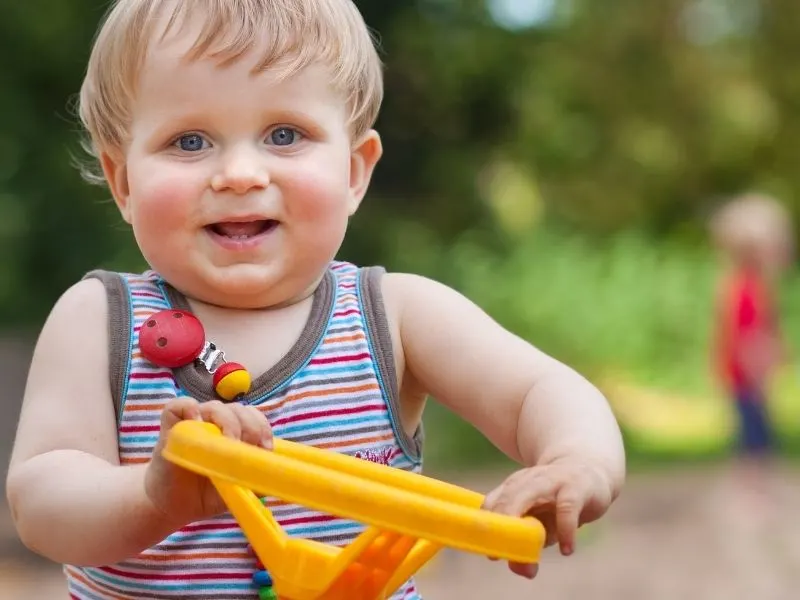 A one year old boy playing with his birthday gift