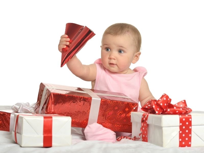 baby girl surrounded by gifts