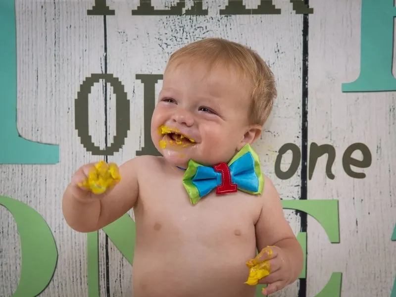 boy having fun at his cake smash photoshoot