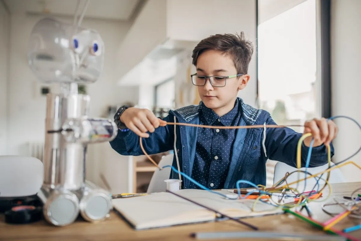 boy assembling robot