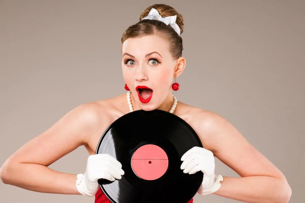 woman holding a vinyl music disk
