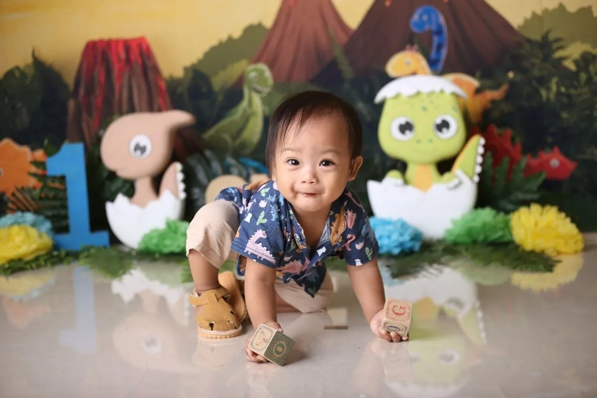 one year old holding wooden blocks