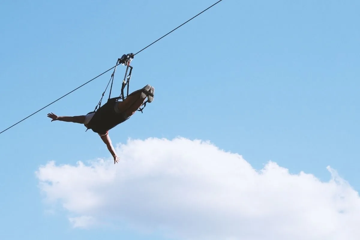 man ziplining horizontally