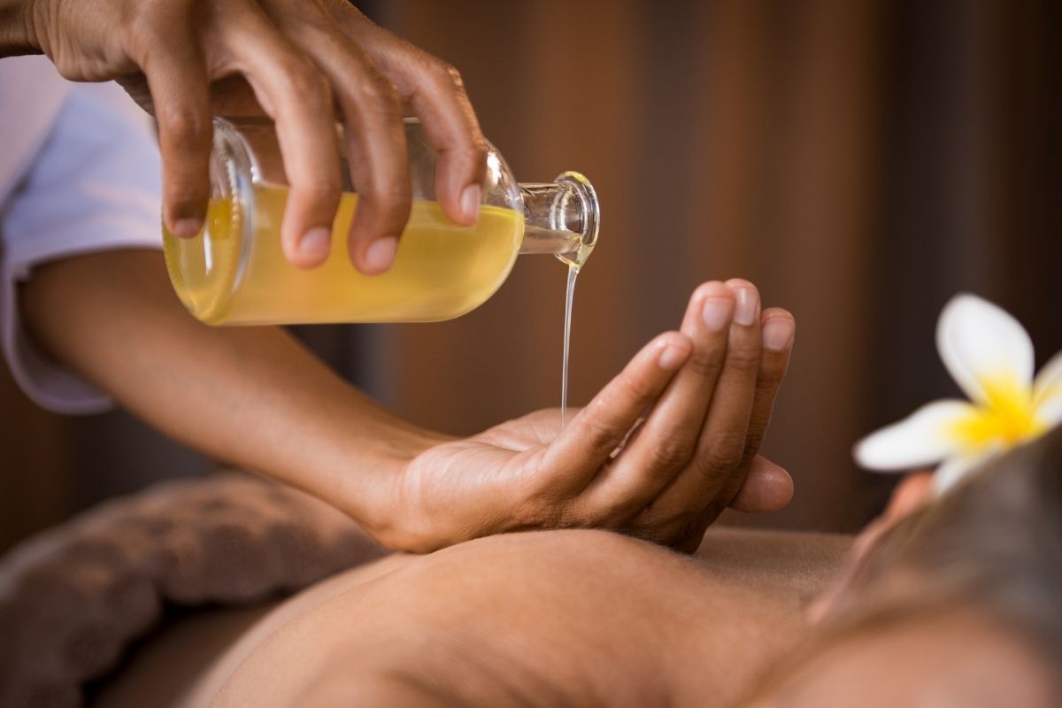 pouring oil in hand getting ready for a massage
